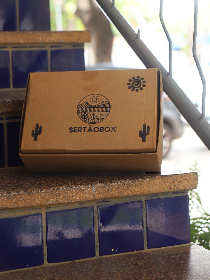 Caixa SertãoBox sobre degraus de azulejo azul